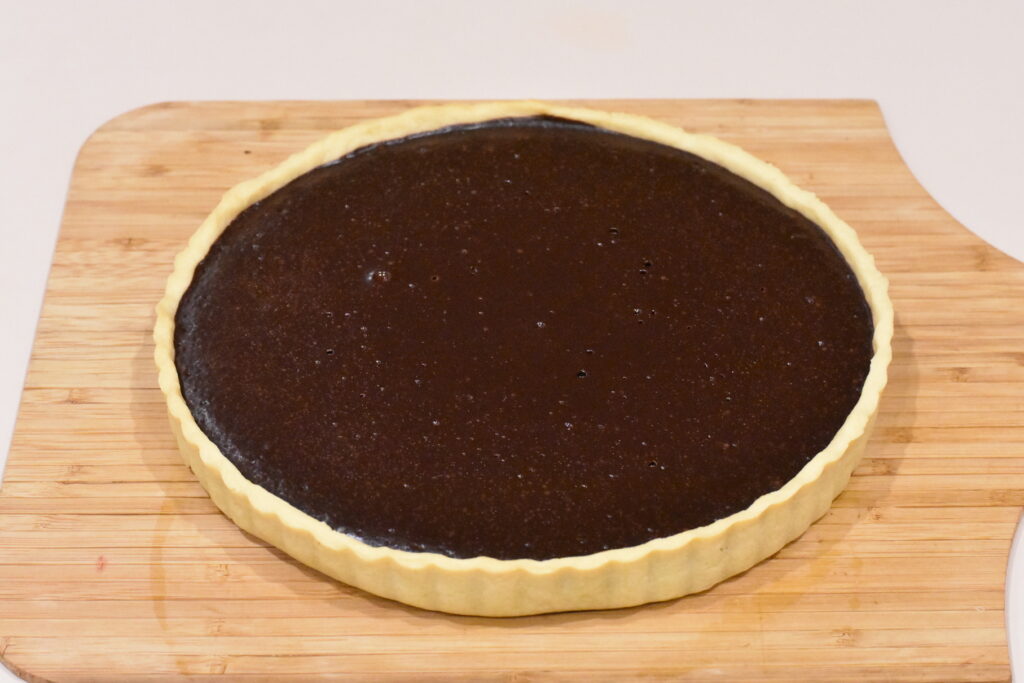 Cooked chocolate layer of tart.
