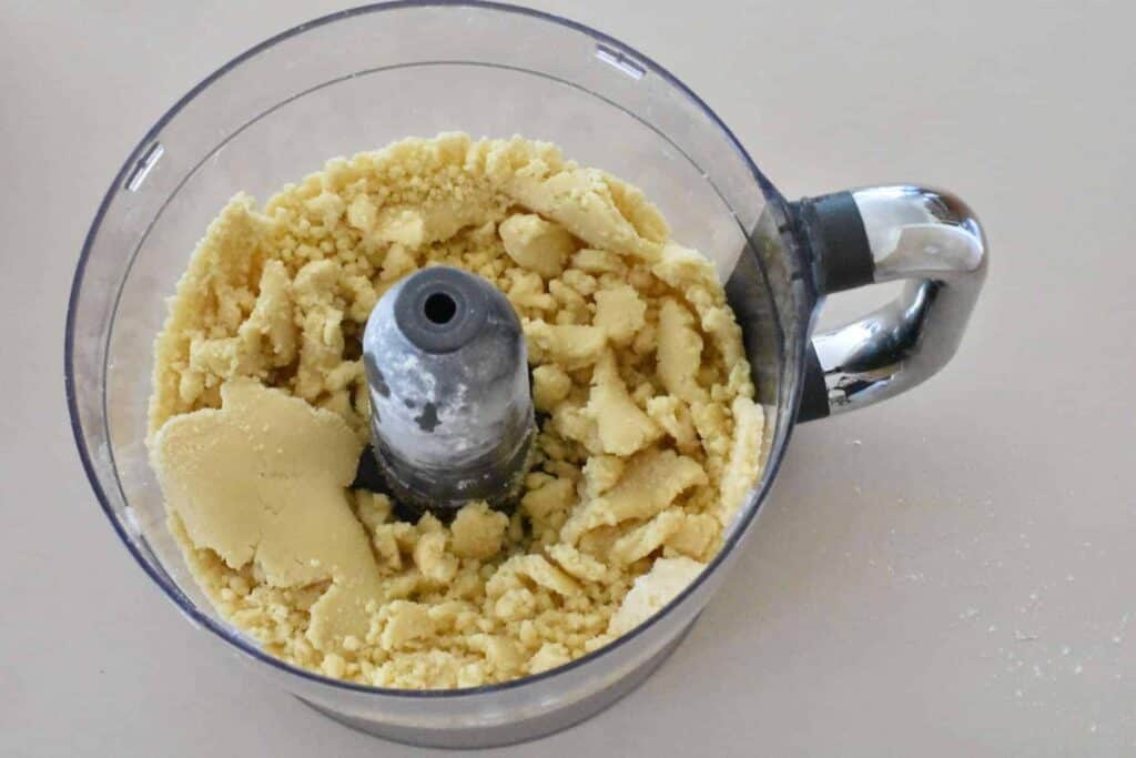 Dough coming together in food processor.