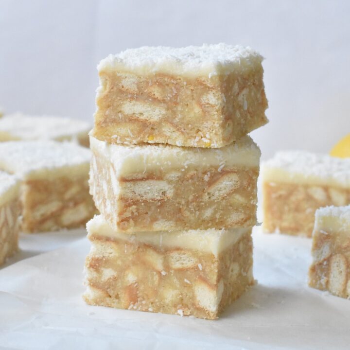 Lemon Coconut Slice squares stacked.