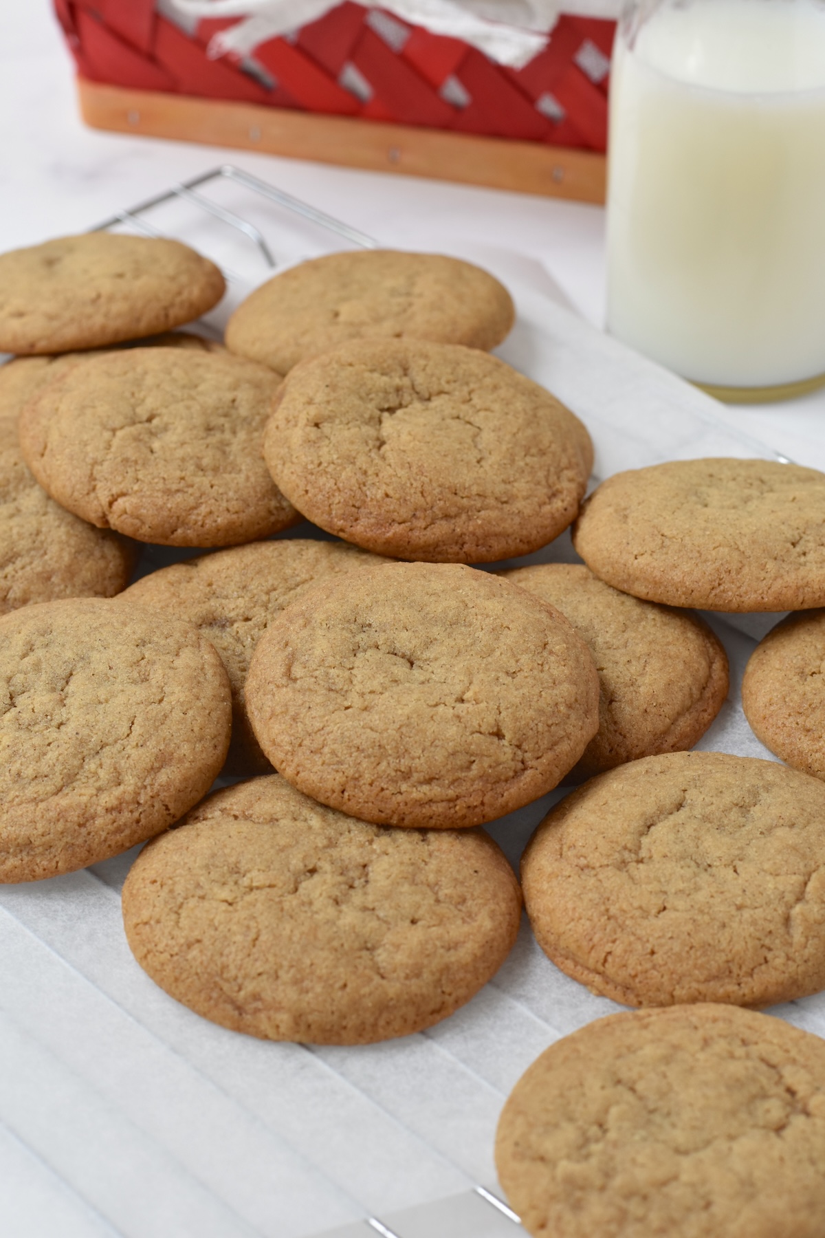 Pile of big soft ginger cookies on cooling rack.